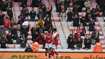 Arsenal's French-born Ivorian midfielder Nicolas Pepe celebrates scoring his team's second goal during the English Premier League football match between Arsenal and Brighton and Hove Albion at the Emirates Stadium in London on May 23, 2021. - - RESTRICTED TO EDITORIAL USE. No use with unauthorized audio, video, data, fixture lists, club/league logos or 'live' services. Online in-match use limited to 120 images. An additional 40 images may be used in extra time. No video emulation. Social media in-match use limited to 120 images. An additional 40 images may be used in extra time. No use in betting publications, games or single club/league/player publications. (Photo by NEIL HALL / POOL / AFP) / RESTRICTED TO EDITORIAL USE. No use with unauthorized audio, video, data, fixture lists, club/league logos or 'live' services. Online in-match use limited to 120 images. An additional 40 images may be used in extra time. No video emulation. Social media in-match use limited to 120 images. An additional 40 images may be used in extra time. No use in betting publications, games or single club/league/player publications. / RESTRICTED TO EDITORIAL USE. No use with unauthorized audio, video, data, fixture lists, club/league logos or 'live' services. Online in-match use limited to 120 images. An additional 40 images may be used in extra time. No video emulation. Social media in-match use limited to 120 images. An additional 40 images may be used in extra time. No use in betting publications, games or single club/league/player publications. (Photo by NEIL HALL/POOL/AFP via Getty Images)
