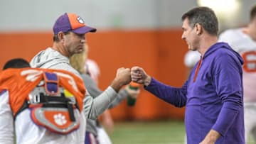 Clemson head coach Dabo Swinney fist bumps Clemson offensive analyst John Grass during practice at the Poe Indoor Facility in Clemson in Clemson, S.C. Friday, December 17, 2021.Clemson Football Practice Dec 17 Friday