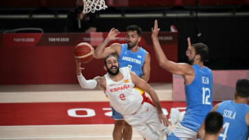 Spain's Ricky Rubio (L) goes to the basket past Argentina's Facundo Campazzo (back) and Marcos Delia in the men's preliminary round group C basketball match between Spain and Argentina during the Tokyo 2020 Olympic Games at the Saitama Super Arena in Saitama on July 29, 2021. (Photo by Aris MESSINIS / AFP) (Photo by ARIS MESSINIS/AFP via Getty Images)