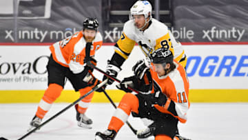 May 4, 2021; Philadelphia, Pennsylvania, USA; Philadelphia Flyers right wing Travis Konecny (11) and Pittsburgh Penguins center Sidney Crosby (87) battle for the puck during the second period at Wells Fargo Center. Mandatory Credit: Eric Hartline-USA TODAY Sports
