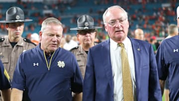 MIAMI GARDENS, FL - NOVEMBER 11: Head coach Brian Kelly of the Notre Dame Fighting Irish walks off the field with Jack Swarbrick, University Vice President James E. Rohr Director of Athletics after the loss to the Miami Hurricanes on November 11, 2017 at Hard Rock Stadium in Miami Gardens, Florida. Miami defeated Notre Dame 41-8. (Photo by Joel Auerbach/Getty Images)