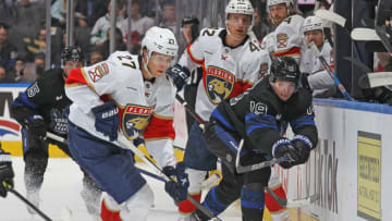 TORONTO, CANADA - MARCH 29: Eetu Luostarinen #27 of the Florida Panthers grabs the puck against Calle Jarnkrok #19 of the Toronto Maple Leafs during an NHL game at Scotiabank Arena on March 29, 2023 in Toronto, Ontario, Canada. The Panthers defeated the Maple Leafs 3-2 in overtime. (Photo by Claus Andersen/Getty Images)