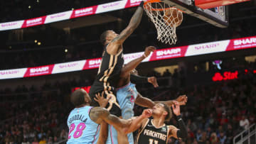 Atlanta Hawks forward John Collins (20) dunks over Miami Heat forward Jimmy Butler (22)(Brett Davis-USA TODAY Sports)