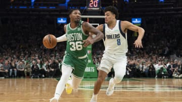 Mar 13, 2022; Boston, Massachusetts, USA; Boston Celtics point guard Marcus Smart (36) dribbles the ball against Dallas Mavericks shooting guard Josh Green (8) defending during the second half at TD Garden. Mandatory Credit: Gregory Fisher-USA TODAY Sports