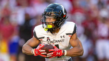 Cincinnati Bearcats Tre Tucker runs ball against the Arkansas Razorbacks at Razorback Stadium. Getty Images.
