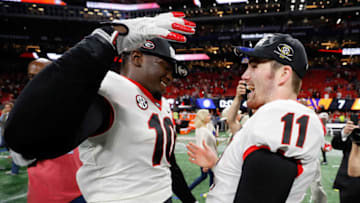 ATLANTA, GA - DECEMBER 02: Jake Fromm #11 celebrates with Malik Herring #10 of the Georgia Bulldogs after beating the Auburn Tigers in the SEC Championship at Mercedes-Benz Stadium on December 2, 2017 in Atlanta, Georgia. (Photo by Kevin C. Cox/Getty Images)