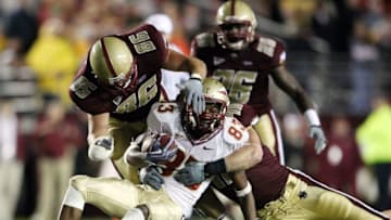 CHESTNUT HILL, MA - OCTOBER 03: Bert Reed #83 of the Florida State Seminoles is tackled by Jim Ramella #86 and Luke Kuechley #40 of the Boston College Eagles on October 3, 2009 at Alumni Stadium in Chestnut Hill, Massachusetts. Boston College defeated Florida State 28-21. (Photo by Elsa/Getty Images)