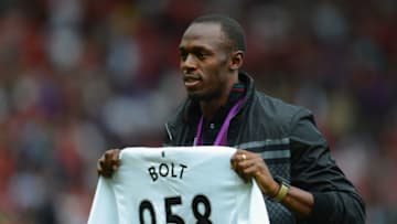 MANCHESTER, ENGLAND - AUGUST 25: Jamaican Athlete Usain Bolt poses with a United shirt prior to the Barclays Premier League match between Manchester United and Fulham at Old Trafford on August 25, 2012 in Manchester, England. (Photo by Shaun Botterill/Getty Images)