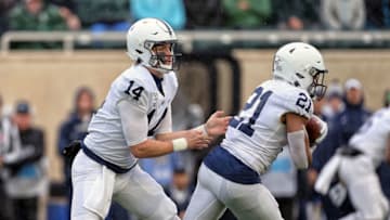 Oct 26, 2019; East Lansing, MI, USA; Penn State Nittany Lions quarterback Sean Clifford (14) hands the ball off to running back Noah Cain (21) during the first quarter of a game against the Michigan State Spartans at Spartan Stadium. Mandatory Credit: Mike Carter-USA TODAY Sports