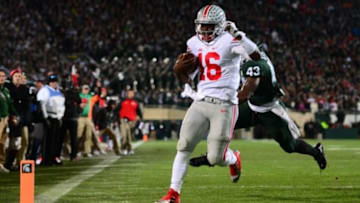 Nov 8, 2014; East Lansing, MI, USA; Ohio State Buckeyes quarterback J.T. Barrett (16) runs the ball into the end zone for a touchdown during the first quarter against the Michigan State Spartans at Spartan Stadium. Mandatory Credit: Andrew Weber-USA TODAY Sports