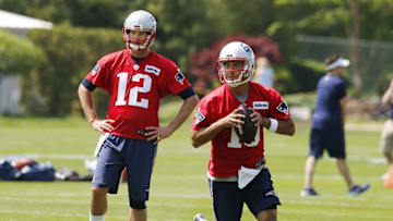 May 26, 2016; Foxborough, MA, USA; New England Patriots quarterback Tom Brady (12) looks on as quarterback Jimmy Garoppolo (10) looks to pass downfield during OTA
