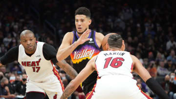 Phoenix Suns guard Devin Booker (1) drives against Miami Heat forward P.J. Tucker (17) and Miami Heat forward Caleb Martin (16)(Joe Camporeale-USA TODAY Sports)