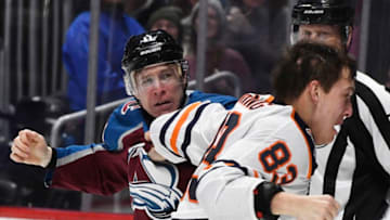 DENVER, CO - DECEMBER 11: Colorado Avalanche left wing Matt Calvert (11) and Edmonton Oilers defenseman Matt Benning (83) exchange punches in a fight in the period at the Pepsi Center December 11, 2018. (Photo by Andy Cross/The Denver Post via Getty Images)