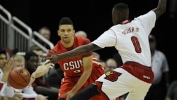 Dec 23, 2014; Louisville, KY, USA; Cal State Northridge Matadors guard/forward Stephan Hicks (3) passes the ball under the pressure of Louisville Cardinals guard Terry Rozier (0) during the first half at KFC Yum! Center. Mandatory Credit: Jamie Rhodes-USA TODAY Sports