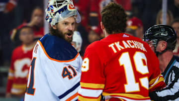 Edmonton Oilers goaltender Mike Smith (41) and Calgary Flames left wing Matthew Tkachuk (19) exchanges words. Mandatory Credit: Sergei Belski-USA TODAY Sports