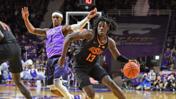 MANHATTAN, KS - FEBRUARY 23: Isaac Likekele #13 of the Oklahoma State Cowboys drives with the ball past Shaun Neal-Williams #1 of the Kansas State Wildcats during the first half on February 23, 2019 at Bramlage Coliseum in Manhattan, Kansas. (Photo by Peter G. Aiken/Getty Images)