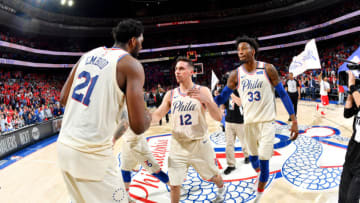 PHILADELPHIA, PA - MAY 7: T.J. McConnell #12 and Joel Embiid #21 of the Philadelphia 76ers high five after the game against the Boston Celtics during Game Four of the Eastern Conference Semifinals of the 2018 NBA Playoffs on May 5, 2018 at Wells Fargo Center in Philadelphia, Pennsylvania. NOTE TO USER: User expressly acknowledges and agrees that, by downloading and or using this photograph, User is consenting to the terms and conditions of the Getty Images License Agreement. Mandatory Copyright Notice: Copyright 2018 NBAE (Photo by Jesse D. Garrabrant/NBAE via Getty Images)