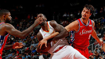 ATLANTA, GA - MARCH 30: Dewayne Dedmon #14 of the Atlanta Hawks grabs a rebound against Dario Saric #9 and Amir Johnson #5 of the Philadelphia 76ers at Philips Arena on March 30, 2018 in Atlanta, Georgia. NOTE TO USER: User expressly acknowledges and agrees that, by downloading and or using this photograph, User is consenting to the terms and conditions of the Getty Images License Agreement. (Photo by Kevin C. Cox/Getty Images)