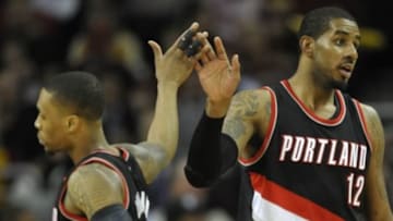 Jan 28, 2015; Cleveland, OH, USA; Portland Trail Blazers forward LaMarcus Aldridge (12) celebrates with guard Damian Lillard (0) in the third quarter against the Cleveland Cavaliers at Quicken Loans Arena. Mandatory Credit: David Richard-USA TODAY Sports