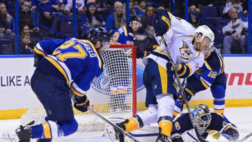 Dec 30, 2016; St. Louis, MO, USA; St. Louis Blues goalie Carter Hutton (40) makes a save against Nashville Predators left wing Colin Wilson (33) as defenseman Alex Pietrangelo (27) defends during the third period at Scottrade Center. The Predators won 4-0. Mandatory Credit: Jeff Curry-USA TODAY Sports