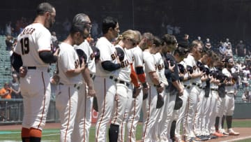 SAN FRANCISCO, CALIFORNIA - MAY 31: Manager Gabe Kapler #19 of the San Francisco Giants stands with his team during the playing of the National Anthem prior to the start of their game against the Los Angeles Angels at Oracle Park on May 31, 2021 in San Francisco, California. (Photo by Thearon W. Henderson/Getty Images)