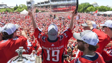 WASHINGTON, DC - JUNE 12: Washington Capitals center Nicklas Backstrom (19) hoists the cup during the Parade for the Stanley Cup Champion Washington Capitals. (Photo by Jonathan Newton/The Washington Post via Getty Images)