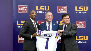 Dec 1, 2021; Baton Rouge, LA, USA; Newly named LSU Tigers head football coach Brian Kelly (middle) is presented with an LSU jersey by University president William F. Tate IV (left) and athletic director Scott Woodward( right) during a press conference at Tiger Stadium. Mandatory Credit: Patrick Dennis-USA TODAY Sports