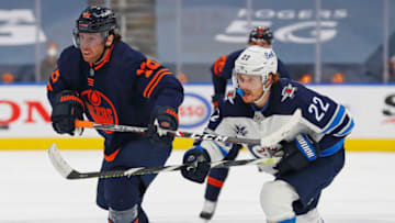 May 19, 2021; Edmonton, Alberta, CAN; Edmonton Oilers forward James Neal (18) and Winnipeg Jets forward Mason Appleton (22) look for a loss puck during the third periodin game one of the first round of the 2021 Stanley Cup Playoffs at Rogers Place. Mandatory Credit: Perry Nelson-USA TODAY Sports
