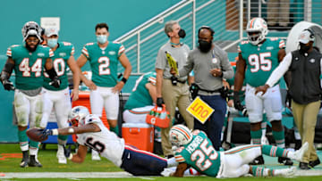Dec 20, 2020; Miami Gardens, Florida, USA; Miami Dolphins cornerback Xavien Howard (25) tackles New England Patriots wide receiver Jakobi Meyers (16) during the second half at Hard Rock Stadium. Mandatory Credit: Jasen Vinlove-USA TODAY Sports