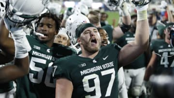 Oct 2, 2021; East Lansing, Michigan, USA; Michigan State Spartans defensive tackle Maverick Hansen (97) sings the fight song with fans after a game against the Western Kentucky Hilltoppers at Spartan Stadium. Mandatory Credit: Raj Mehta-USA TODAY Sports