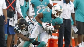 Sep 20, 2015; Jacksonville, FL, USA; Jacksonville Jaguars cornerback Aaron Colvin (22) tackles Miami Dolphins wide receiver Rishard Matthews (18) during the second half of an NFL Football game at EverBank Field. The Jacksonville Jaguars won 23-20. Mandatory Credit: Reinhold Matay-USA TODAY Sports