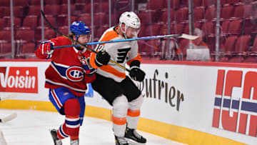 MONTREAL, QC - DECEMBER 16: Mike Hoffman #68 of the Montreal Canadiens and Rasmus Ristolainen #70 of the Philadelphia Flyers skate for the puck during the second period at Centre Bell on December 16, 2021 in Montreal, Canada. (Photo by Minas Panagiotakis/Getty Images)