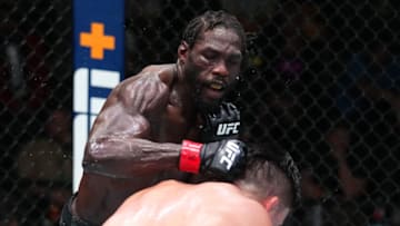 LAS VEGAS, NEVADA - AUGUST 21: (L-R) Jared Cannonier punches Kelvin Gastelum in a middleweight fight during the UFC Fight Night event at UFC APEX on August 21, 2021 in Las Vegas, Nevada. (Photo by Chris Unger/Zuffa LLC)