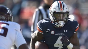 Auburn football running back Tank Bigsby (4) weighs his options as he avoids a tackle at Jordan-Hare Stadium in Auburn, Ala., on Saturday, Dec. 5, 2020.
