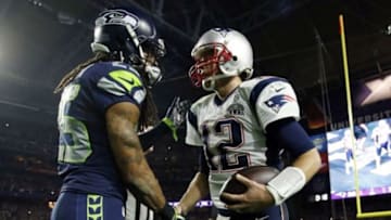 Feb 1, 2015; Glendale, AZ, USA; Seattle Seahawks cornerback Richard Sherman (left) shakes hands with New England Patriots quarterback Tom Brady (12) after Super Bowl XLIX at University of Phoenix Stadium. Mandatory Credit: Mark J. Rebilas-USA TODAY Sports