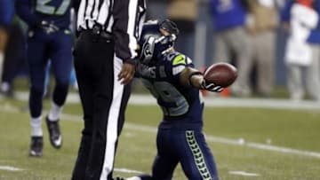 January 10, 2015; Seattle, WA, USA; Seattle Seahawks free safety Earl Thomas (29) celebrates after he intercepts a pass intended for Carolina Panthers wide receiver Kelvin Benjamin (13) during the first half in the 2014 NFC Divisional playoff football game at CenturyLink Field. Mandatory Credit: Joe Nicholson-USA TODAY Sports