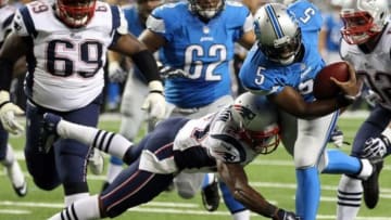 Aug 22, 2013; Detroit, MI, USA; Detroit Lions quarterback Thad Lewis (5) is tackled by New England Patriots defensive end Jake Bequette (92) during 2nd half at Ford Field. Lions won 40-9. Mandatory Credit: Mike Carter-USA TODAY Sports