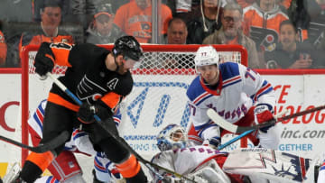 PHILADELPHIA, PA - NOVEMBER 23: Sean Couturier #14 of the Philadelphia Flyers battles for the puck under goaltender Henrik Lundqvist #30 of the New York Rangers with Tony DeAngelo #77 on November 23, 2018 at the Wells Fargo Center in Philadelphia, Pennsylvania. (Photo by Len Redkoles/NHLI via Getty Images)