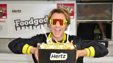 LOS ANGELES, CALIFORNIA - MAY 25: Foodgod, makes a surprise appearance at the Hertz lot at LAX. As thousands of travelers collect their rental cars on this busy travel holiday weekend, they were treated to tacos and poutine from two of LA’s most loved food trucks. According to Foodgod, “Hertz is all about connecting their customers to the moments that matter with a great travel experience so I’m excited to be here today to help give their customers a taste of LA before they even hit the road!” (Photo by Jerod Harris/Getty Images for Hertz)
