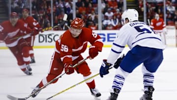 Mar 13, 2016; Detroit, MI, USA; Detroit Red Wings left wing Teemu Pulkkinen (56) skates with the puck defended by Toronto Maple Leafs defenseman Jake Gardiner (51) in the third period at Joe Louis Arena. Toronto won 1-0. Mandatory Credit: Rick Osentoski-USA TODAY Sports