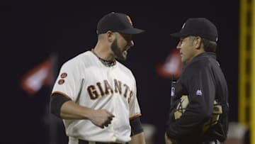 Jul 28, 2016; San Francisco, CA, USA; San Francisco Giants relief pitcher Albert Suarez (56) talks with umpire James Hoye (92) at the end of the seventh inning during the game with the Washington Nationals at AT&T Park. Mandatory Credit: Kenny Karst-USA TODAY Sports