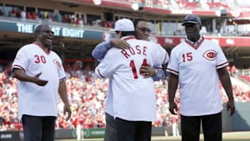 Jun 24, 2016; Cincinnati, OH, USA; Cincinnati Reds former great Pete Rose (14) is hugged by former teammate Tony Perez during a ceremony honoring the 1976 World Series champion team before a game with the San Diego Padres at Great American Ball Park. Former players Ken Griffey (30) and George Foster (15) watch. Mandatory Credit: David Kohl-USA TODAY Sports