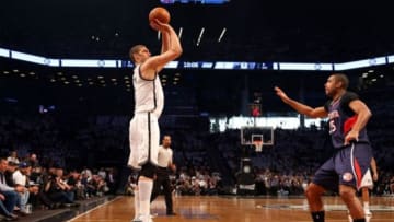 Apr 27, 2015; Brooklyn, NY, USA; Brooklyn Nets center Brook Lopez (11) shoots for three over Atlanta Hawks center Al Horford (15) during the first quarter in game four of the first round of the NBA Playoffs. at Barclays Center. Mandatory Credit: Anthony Gruppuso-USA TODAY Sports