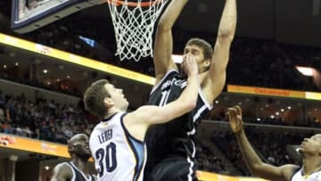 Nov 30, 2013; Memphis, TN, USA; Brooklyn Nets center Brook Lopez (11) grabs a rebound defended by Memphis Grizzlies forward Jon Leuer (30) at FedExForum. Brooklyn defeated Memphis 97-88. Mandatory Credit: Nelson Chenault-USA TODAY Sports