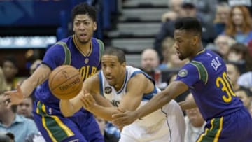 Feb 8, 2016; Minneapolis, MN, USA; Minnesota Timberwolves guard Andre Miller (24) passes the ball between New Orleans Pelicans forward Anthony Davis (23) and guard Norris Cole (30) in the first half at Target Center. Mandatory Credit: Jesse Johnson-USA TODAY Sports