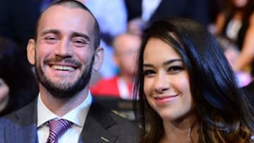 Jul 11, 2015; Las Vegas, NV, USA; Former WWE superstars Phil Brooks aka CM Punk and April Mendez-Brooks aka AJ Lee attend the Chad Mendes (not pictured) and Conor McGregor (not pictured) interim featherweight title bout during UFC 189 at MGM Grand Garden Arena. McGregor won via second round TKO. Mandatory Credit: Joe Camporeale-USA TODAY Sports
