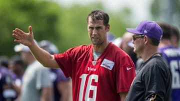 Jun 17, 2014; Eden Prairie, MN, USA; Minnesota Vikings head coach Mike Zimmer speaks with quarterback Matt Cassel (16) during practice at Winter Park. Mandatory Credit: Bruce Kluckhohn-USA TODAY Sports