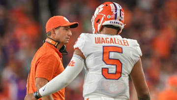 Clemson head coach Dabo Swinney talks with quarterback D.J. Uiagalelei (5) after throwing a pass to wide receiver Joseph Ngata (10) for a touchdown near Syracuse defensive back Darian Chestnut (20) during the second quarter at the Carrier Dome in Syracuse, New York, Friday, October 15, 2021.Ncaa Football Clemson At Syracuse