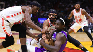 Jrue Holiday #21 of the Milwaukee Bucks competes for a loose ball against Jimmy Butler #22 and Gabe Vincent #2 of the Miami Heat(Photo by Megan Briggs/Getty Images)