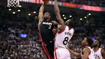 May 11, 2016; Toronto, Ontario, CAN; Miami Heat guard Dwyane Wade (3) goes to the basket but is denied by Toronto Raptors center Bismack Biyombo (8) in game five of the second round of the NBA Playoffs at Air Canada Centre. Mandatory Credit: Tom Szczerbowski-USA TODAY Sports